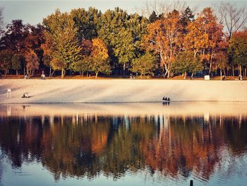 Scenic view of lake by trees during autumn