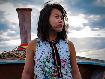 Confident young woman standing on boat deck