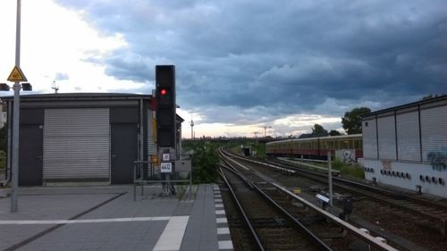 Railroad track against cloudy sky