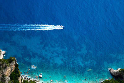 Aerial view of sea against blue sky