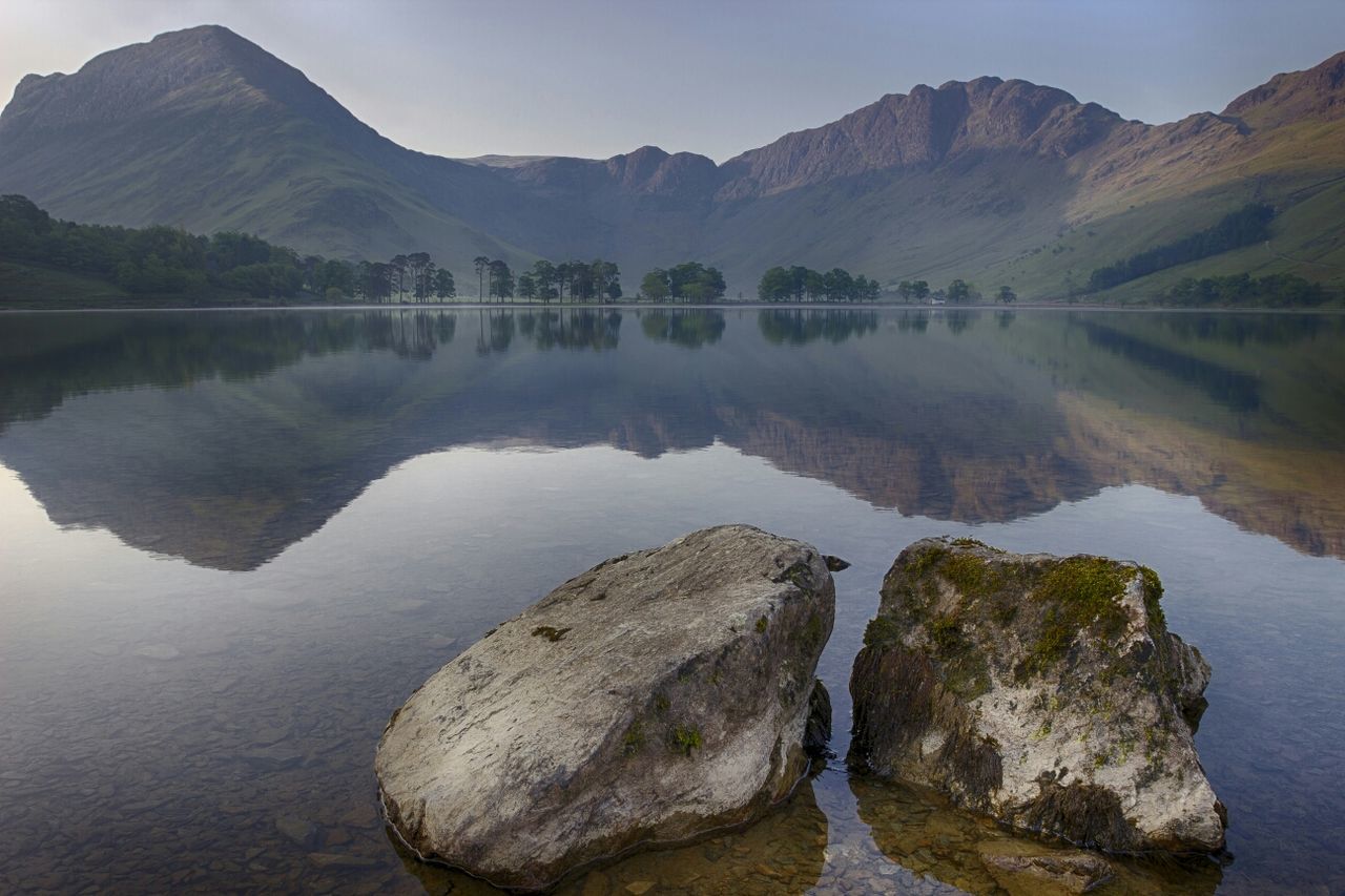 water, mountain, lake, reflection, tranquil scene, tranquility, scenics, beauty in nature, mountain range, nature, waterfront, idyllic, river, rock - object, sky, non-urban scene, outdoors, no people, day, calm