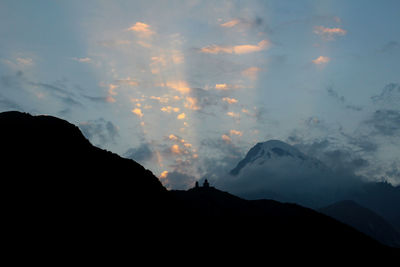 Low angle view of silhouette mountains against sky at sunset