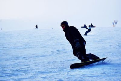 Mid adult man skiing on snow covered landscape