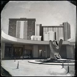 Statue against building in city