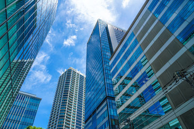 Low angle view of modern buildings against sky in city