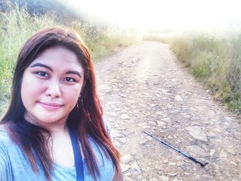 Portrait of a smiling young woman with road