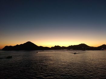 Scenic view of sea against clear sky during sunset