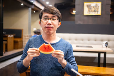 Portrait of man holding ice cream