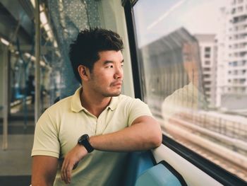 Man sitting on train window