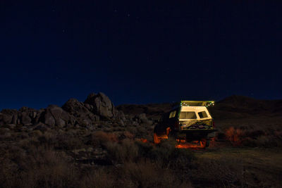 Built structure on field against clear sky at night