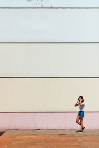 Woman standing against wall