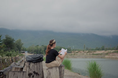 Young women reading book outdoor surrounded by fresh environment , education and sloe growth concept