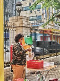 Woman standing by food outdoors