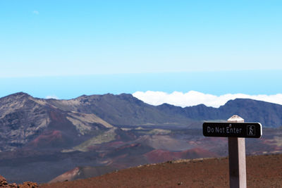 Close-up of road sign against clear sky