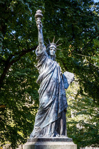 Low angle view of statue against trees