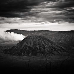 View of volcanic landscape against cloudy sky