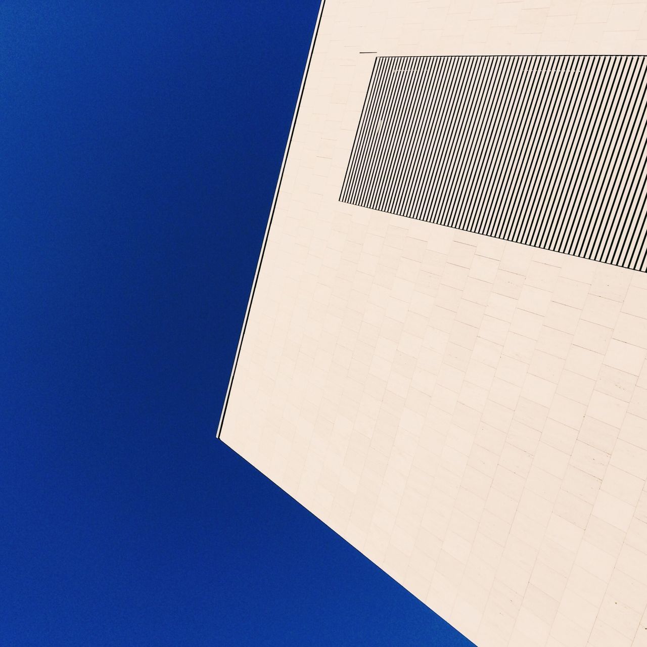 clear sky, low angle view, architecture, copy space, built structure, pattern, modern, building exterior, tower, design, blue, no people, tall - high, paper, part of, shadow, day, close-up, triangle shape, sunlight
