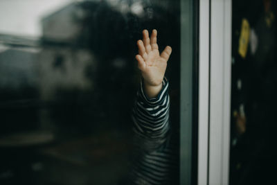 Close-up of toddler hand on glass window