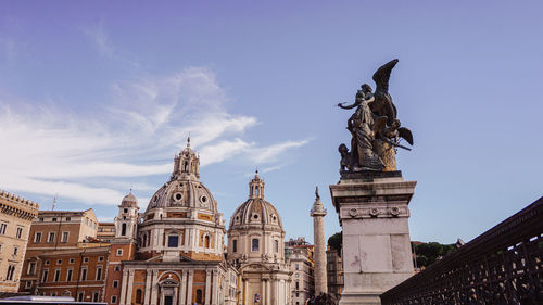 Low angle view of statue of historic building against sky