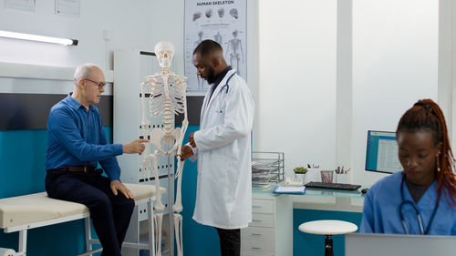 Female doctor examining chemical in laboratory