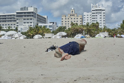 Midsection of man in city against sky