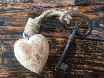 Close-up of heart shape hanging on metal door