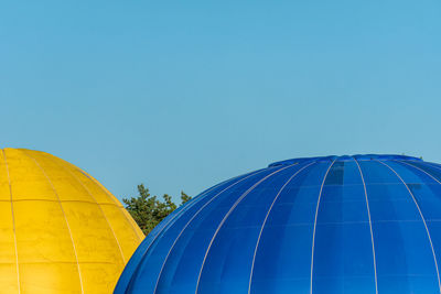 Low angle view of hot air balloon against blue sky