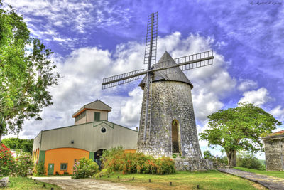 Low angle view of traditional windmill against sky