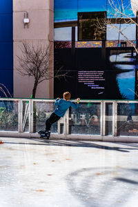 Man jumping in city during winter