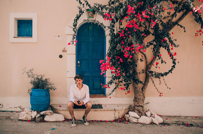 Young woman outside house against building