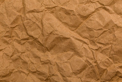 Ragged crumpled brown kraft paper texture and full frame background