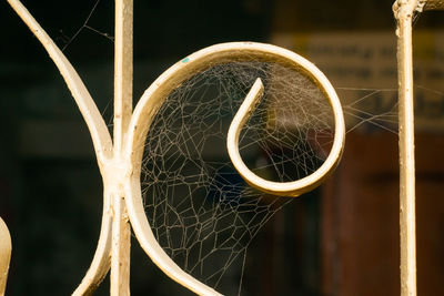 Close-up of spider web on metal