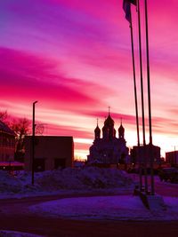 Buildings against sky during winter at dusk