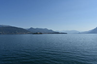 Scenic view of lake against clear blue sky