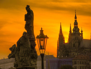 Statue of historic building against sky during sunset