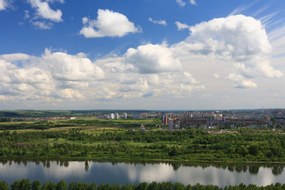 Scenic view of lake and buildings against sky