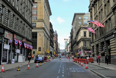 City street amidst buildings against sky