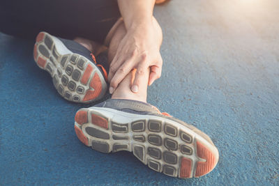 Low section of woman wearing shoes