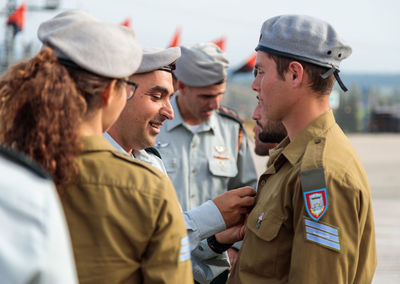 Close-up of female friends standing in front of man