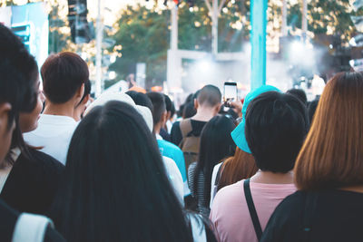 Rear view of people enjoying in city