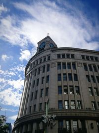 Low angle view of building against cloudy sky