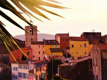 Town against sky at sunset