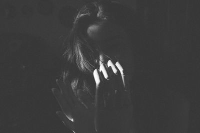 Close-up of depressed woman in darkroom