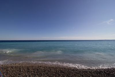 Scenic view of sea against clear blue sky