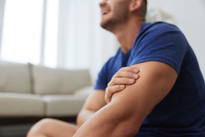 Side view of man exercising at home