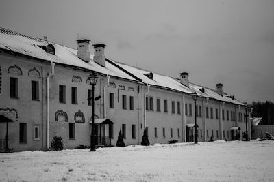 Low angle view of snow covered buildings against sky