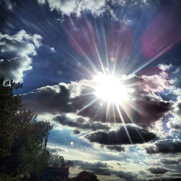 sun, sunbeam, sky, sunlight, lens flare, low angle view, cloud - sky, tree, beauty in nature, bright, nature, cloud, sunny, built structure, tranquility, cloudy, silhouette, scenics, architecture, back lit