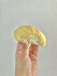 Midsection of person holding apple against white background