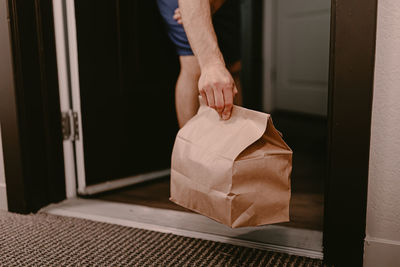 Midsection of woman holding suitcase