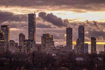 View of modern buildings against sky during sunset